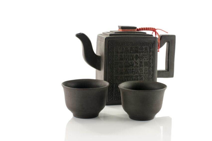 asian teapot and two cups on white
