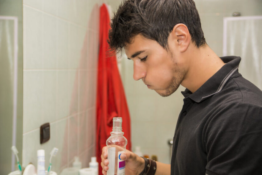 Head and Shoulders Close Up of Attractive Young Man with Dark Hair Rinsing 