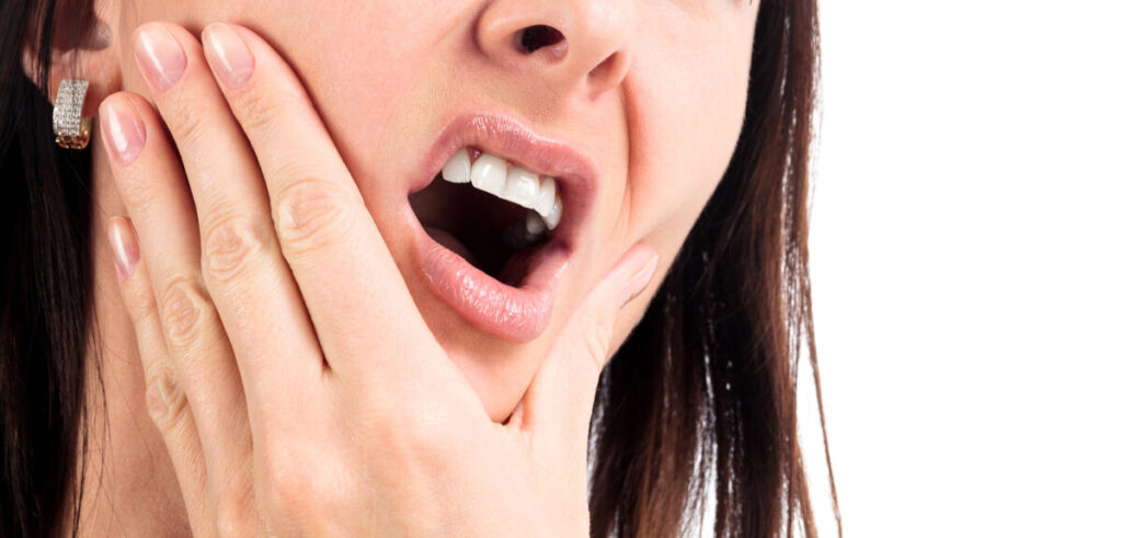 Woman with a tooth pain, isolated on a white background