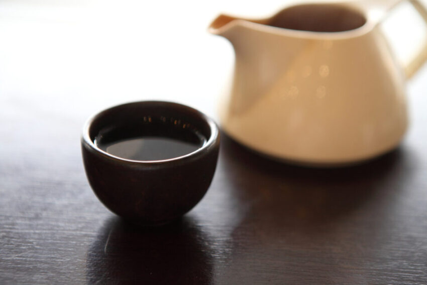 Cup of Pau D'arco Tea, next to beige tea pot