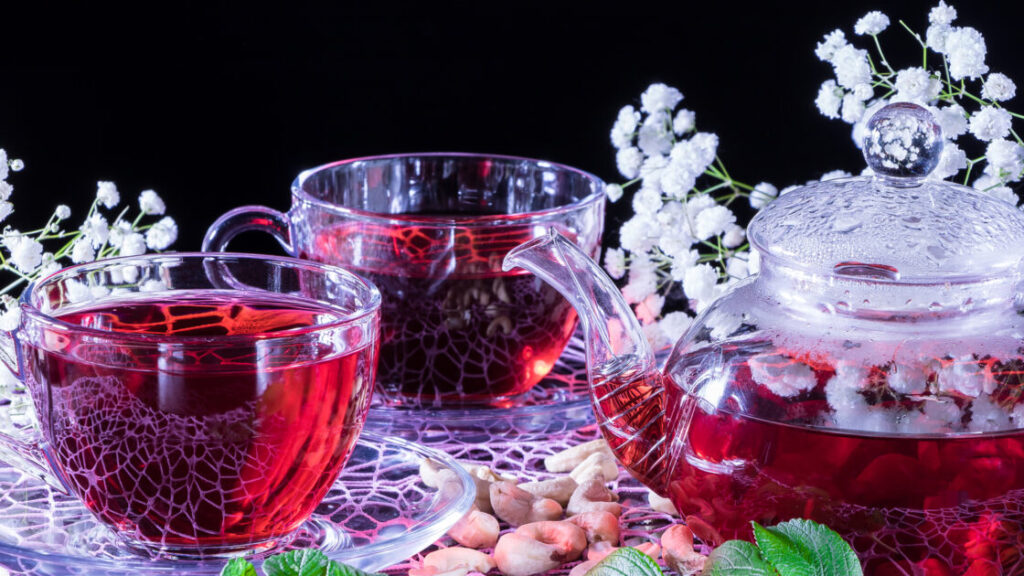 Hibiscus Red tea mug with carnation flowers close-up horizontal
