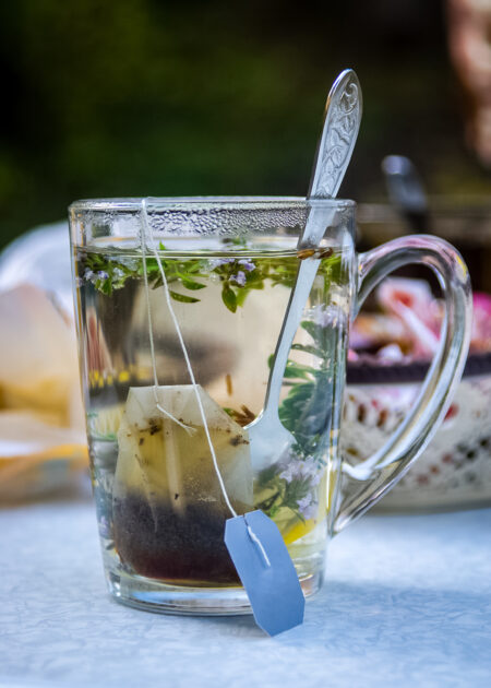 Transparent mug with tea. Brewing tea in bag. Brewing herbal tea. Herbal tea.