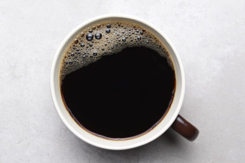 Black Coffee in Brown Mug on Gray Tile