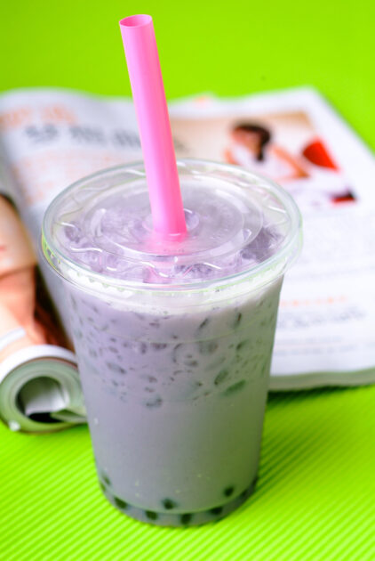 Purple Boba Tea in a plastic cup, with pink straw