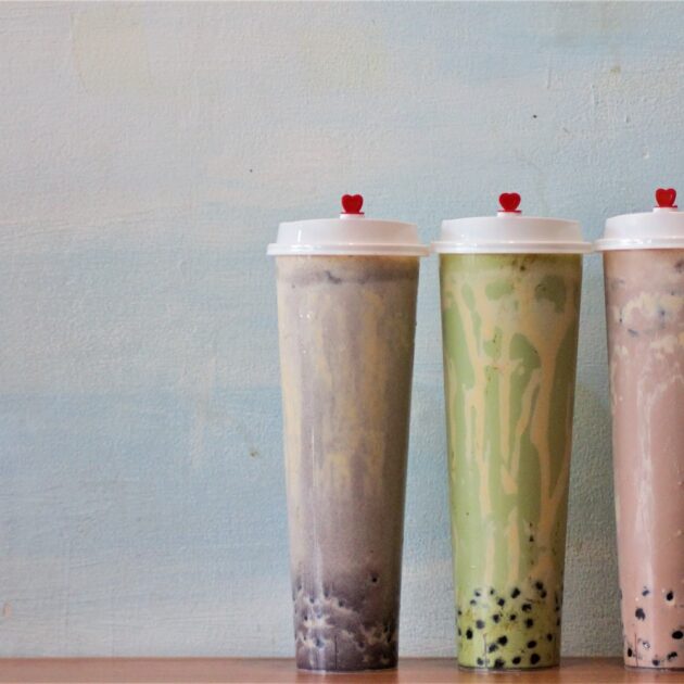 3 tall glasses of different color and flavor Boba Tea
