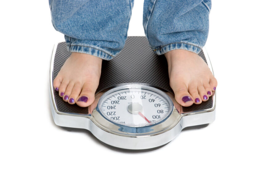 Woman standing on weight scale