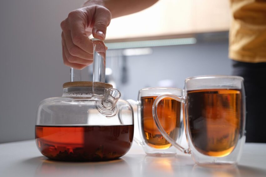 Black tea in a transparent teapot and cups. 