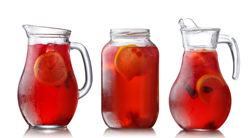 Collection of misted jugs with iced hibiscus lemon tea also known as aqua fresca, karkade or red sorrel