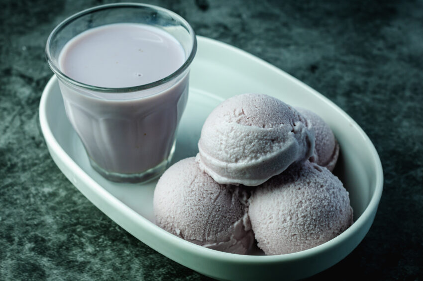 Homemade taro ice-cream and taro milk tea on a white plate.