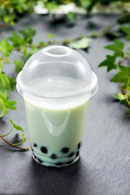 Honeydew bubble  tea with milk and tapioca pearls in plastic cup