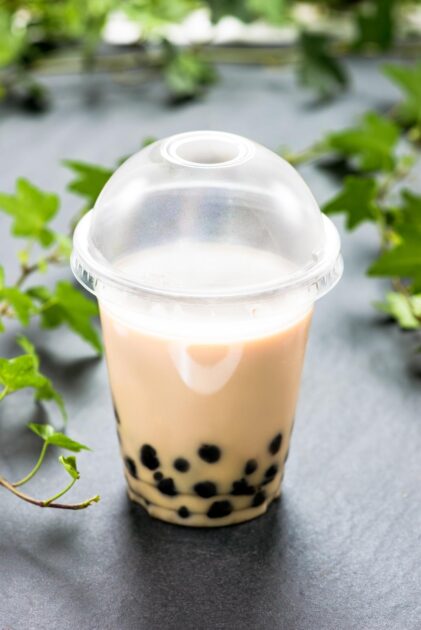Bubble boba coffee milk tea with tapioca pearls in plastic cup