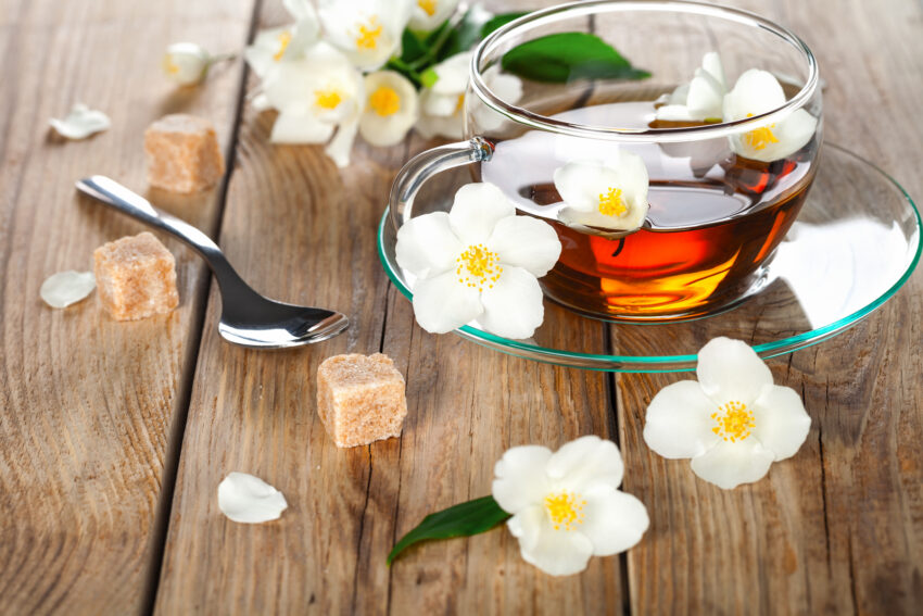 Jasmine tea with jasmine herb flower on wooden table background