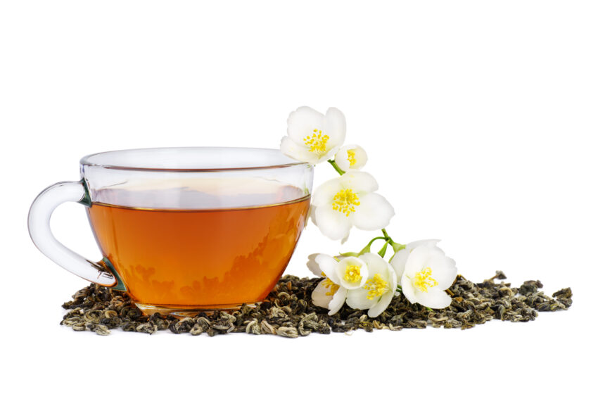 Tea and jasmine flowers isolated on white background