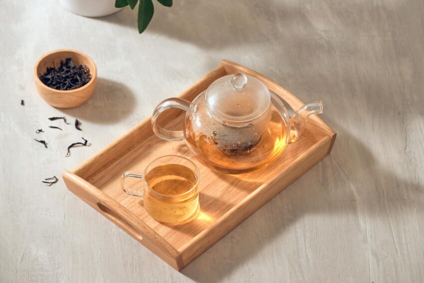 Oolong Tea in a transparent cup and teapot on a wooden background