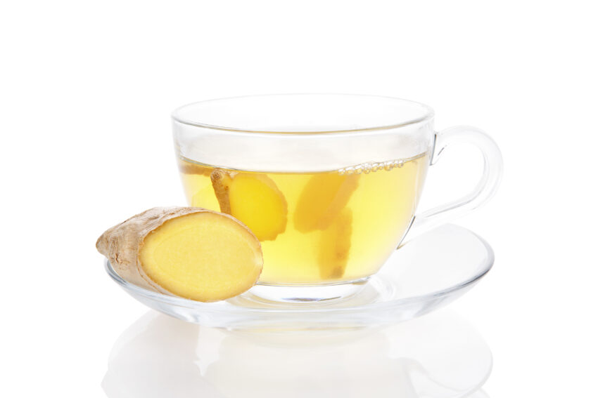 Delicious healthy ginger tea in transparent tea cup isolated on white background. One of the best tea's for alcohol detox.