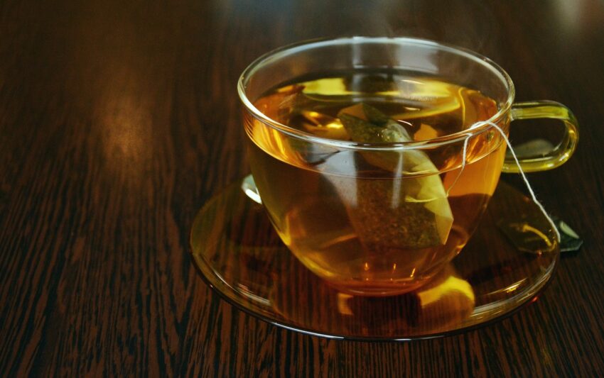 Tea in a glass mug on a wood table